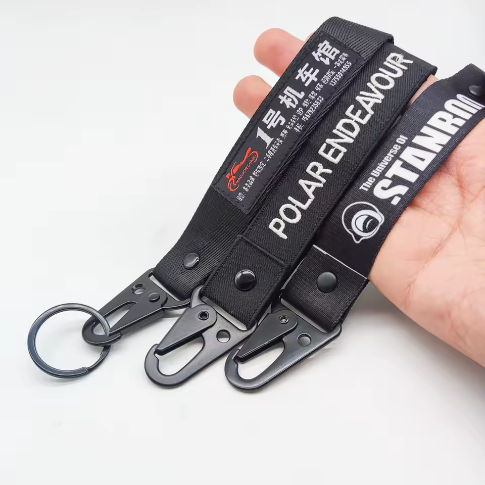 Assorted full-color sublimation lanyard key tags arranged as production samples